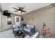 Cozy screened patio with comfortable seating, ceiling fan, and outdoor decor at 929 Eastmont Ct, The Villages, FL 32162