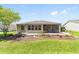 The house has a well-kept backyard with mature trees, landscaping, screened in porch and outdoor grill at 929 Eastmont Ct, The Villages, FL 32162