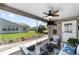 Relax on the screened patio with ceiling fan, TV, and comfortable seating, perfect for enjoying the outdoors at 929 Eastmont Ct, The Villages, FL 32162