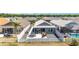 Aerial view of backyard, with covered patio and outdoor seating area at 947 Couture St, The Villages, FL 32163
