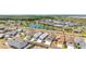 Aerial view of a neighborhood with a lake and manicured lawns on a sunny day at 947 Couture St, The Villages, FL 32163