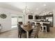 Open-concept dining area featuring stylish table setting adjacent to a modern kitchen with stainless steel appliances at 947 Couture St, The Villages, FL 32163