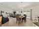 Open living room with views to outdoor patio, and eat-in kitchen with modern countertops and barstool seating at 947 Couture St, The Villages, FL 32163