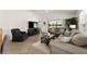 Comfortable living room area with ample seating, view to the outdoor, and a large television at 947 Couture St, The Villages, FL 32163