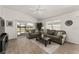 Cozy living room features sliding glass door with backyard access and modern furniture at 947 Couture St, The Villages, FL 32163