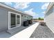 An outdoor patio with sliding glass doors, outdoor cooking, and dining at 947 Couture St, The Villages, FL 32163
