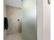 Modern tiled shower with glass door and brushed nickel fixtures at 947 Couture St, The Villages, FL 32163