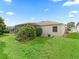 The home's manicured backyard features lush lawn and mature plantings, highlighting its privacy and outdoor space at 9621 Se 168Th Maplesong Ln, The Villages, FL 32162