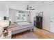 Bedroom features a patterned bedspread, hardwood floors, and a window with natural light at 9621 Se 168Th Maplesong Ln, The Villages, FL 32162