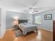 Spacious bedroom with hardwood floors, ceiling fan, and natural light from the window at 9621 Se 168Th Maplesong Ln, The Villages, FL 32162