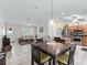 Open-concept dining area that flows into the living room and modern kitchen design at 9621 Se 168Th Maplesong Ln, The Villages, FL 32162