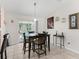 The dining area features contemporary lighting, modern décor and access to a sliding glass door at 9621 Se 168Th Maplesong Ln, The Villages, FL 32162