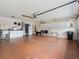 Spacious garage with white cabinets, offering ample storage and workspace, with painted floors and utility sink at 9621 Se 168Th Maplesong Ln, The Villages, FL 32162