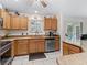 Well-lit kitchen boasts granite counters, stainless steel appliances, and ample cabinet space at 9621 Se 168Th Maplesong Ln, The Villages, FL 32162