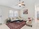 Bright living room features a comfortable sofa, sitting chairs, decorative rug and ample natural light at 9621 Se 168Th Maplesong Ln, The Villages, FL 32162