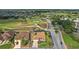 Aerial view of property on golf course with mature landscaping and fenced-in backyard at 1606 Mount Croghan Trl, The Villages, FL 32162