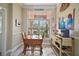 Bright breakfast nook with windows providing natural light, a small wooden table, and neutral decor at 1606 Mount Croghan Trl, The Villages, FL 32162
