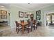 Formal dining room with wood table, six chairs, chandelier, and neutral paint color at 1606 Mount Croghan Trl, The Villages, FL 32162