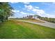 Community golf entrance and guardhouse with palm trees and landscaping at 1606 Mount Croghan Trl, The Villages, FL 32162