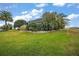 Lush landscaping surrounds this home, complemented by a well-maintained lawn and vibrant foliage at 1606 Mount Croghan Trl, The Villages, FL 32162
