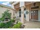 Charming front porch with a water fountain, seating, and lush landscaping, creating a welcoming entrance at 1606 Mount Croghan Trl, The Villages, FL 32162