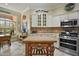 Bright kitchen with white cabinetry, tile backsplash, stainless steel appliances, and center island at 1606 Mount Croghan Trl, The Villages, FL 32162