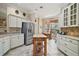 Bright kitchen features stainless appliances, island, tile floors, and a breakfast nook with beautiful natural light at 1606 Mount Croghan Trl, The Villages, FL 32162