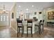 Open kitchen features bar seating, pendant lights, stainless appliances, and lots of cabinet space at 1606 Mount Croghan Trl, The Villages, FL 32162