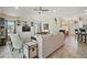 Bright living room featuring built-in shelving, comfortable seating, and easy access to kitchen and dining areas at 1606 Mount Croghan Trl, The Villages, FL 32162