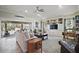 Spacious living room with sliding glass doors to the pool, built-in shelving, and comfortable seating at 1606 Mount Croghan Trl, The Villages, FL 32162
