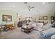 Inviting living room showcasing an open layout connecting to the kitchen and dining area, perfect for entertaining at 1606 Mount Croghan Trl, The Villages, FL 32162