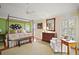 Spacious main bedroom with sitting area, hardwood floors, canopy bed, and an ensuite bathroom at 1606 Mount Croghan Trl, The Villages, FL 32162