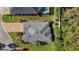 Birds eye view of the roof of a well-maintained home with green lawn and tropical landscaping at 10282 Julia Isles Ave, Oxford, FL 34484