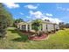Expansive backyard with well-maintained lawn, landscaped beds, and covered patio, perfect for outdoor living at 10282 Julia Isles Ave, Oxford, FL 34484
