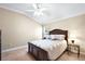 Bedroom with ceiling fan, large bed, and window, creating a relaxing atmosphere at 10282 Julia Isles Ave, Oxford, FL 34484