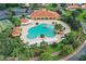 Resort style pool featuring rock waterfall and lush tropical landscaping at 10282 Julia Isles Ave, Oxford, FL 34484