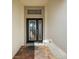 Close-up of decorative front door featuring glass design and brick tiled entry at 10282 Julia Isles Ave, Oxford, FL 34484