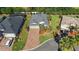 Aerial view of home with brick driveway, mature landscaping and a well manicured lawn at 10282 Julia Isles Ave, Oxford, FL 34484