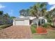 Charming single-story home featuring a brick driveway and well-maintained landscaping at 10282 Julia Isles Ave, Oxford, FL 34484