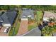 Aerial view of home with brick driveway, mature landscaping and a well manicured lawn at 10282 Julia Isles Ave, Oxford, FL 34484