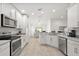 Well-lit kitchen features stainless steel appliances and seamless flow to the dining area at 10282 Julia Isles Ave, Oxford, FL 34484