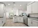 Bright kitchen with stainless steel appliances and adjacent dining area, perfect for Gathering meals at 10282 Julia Isles Ave, Oxford, FL 34484
