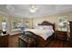 Spacious main bedroom with a tray ceiling, ample natural light, and elegant furnishings at 10282 Julia Isles Ave, Oxford, FL 34484