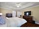 Comfortable main bedroom with a large bed, classic dresser, and easy access to adjacent rooms at 10282 Julia Isles Ave, Oxford, FL 34484