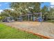 View of the community playground with mulch base and mature landscaping at 10282 Julia Isles Ave, Oxford, FL 34484