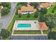 Aerial view of a beautiful community pool and hot tub with tile roofing and ample seating at 10282 Julia Isles Ave, Oxford, FL 34484