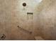 Close-up of the tiled shower featuring built-in niche and grab bar at 10282 Julia Isles Ave, Oxford, FL 34484