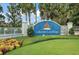 Entrance sign for Lakeside Landings community with a sailboat and lush landscaping at 10282 Julia Isles Ave, Oxford, FL 34484
