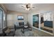 Bright sunroom features neutral decor, comfortable seating, and a sliding glass door at 10282 Julia Isles Ave, Oxford, FL 34484
