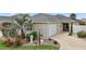 Charming home with landscaped front yard and attached two-car garage at 1084 Becker Ave, The Villages, FL 32163